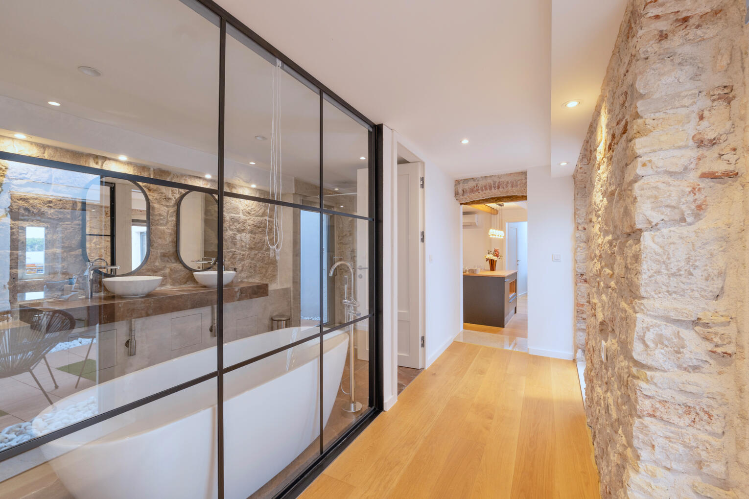 Hallway towards kitchen with view of the bathroom Hallway towards kitchen with view of the bathroom
